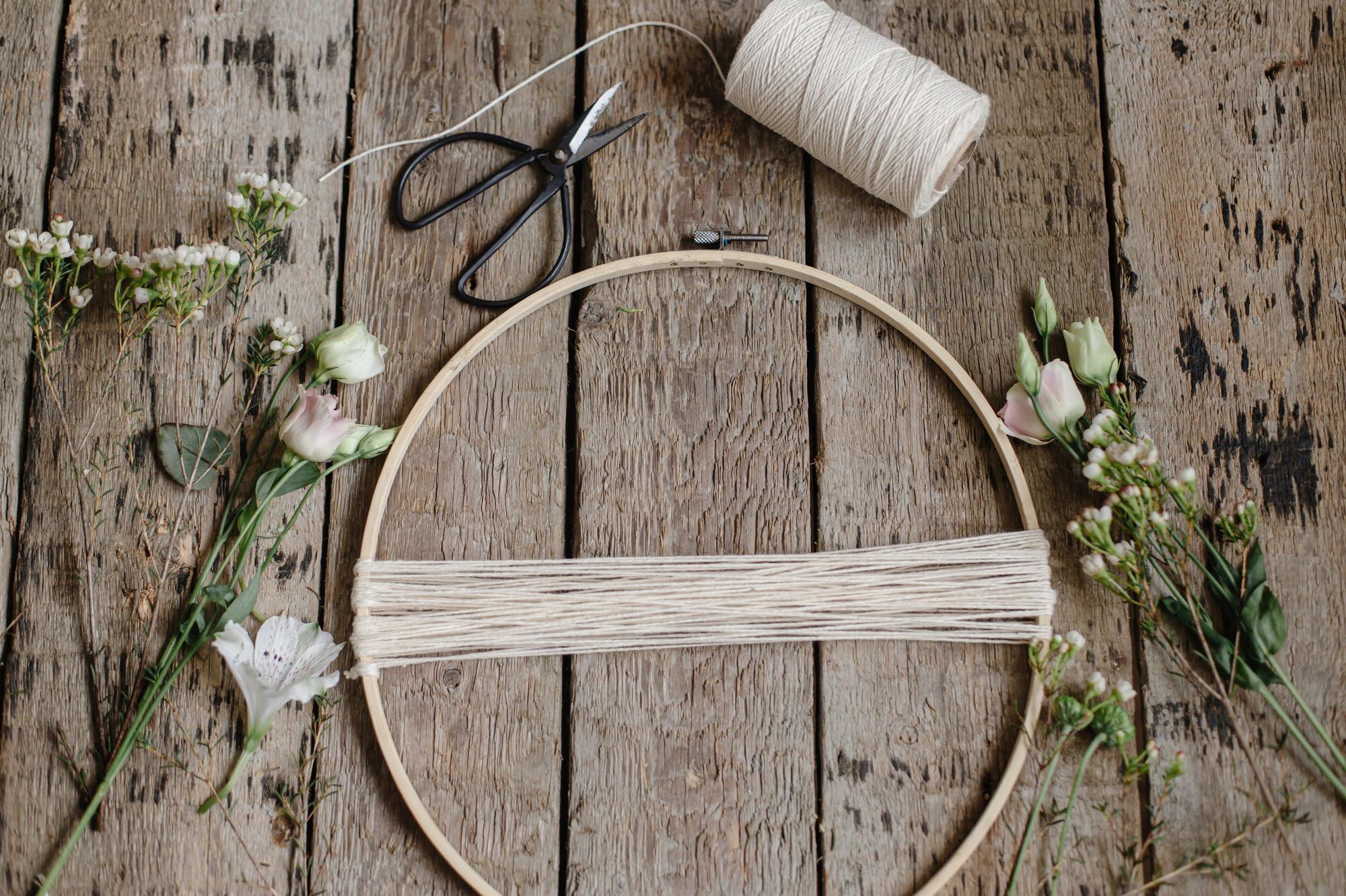 studio workspace with threads and embroidery hoop