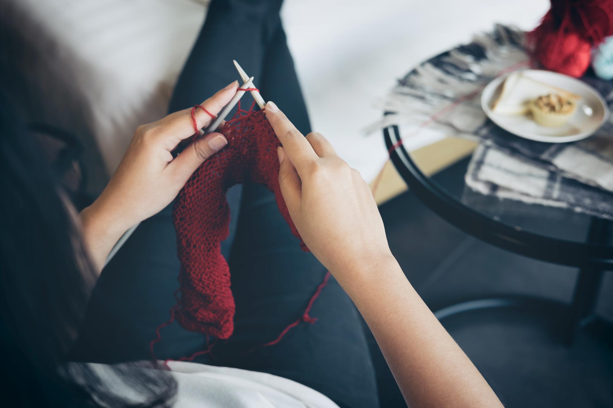 artisan hand embroidering silk thread on fabric